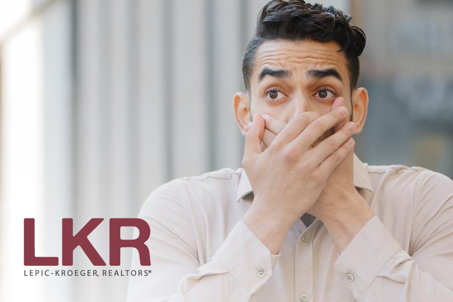 Man looking shocked/scared with the LKR logo.